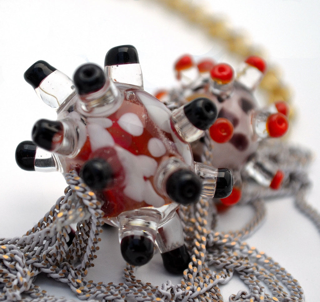 Day at the beach. Murano handmade glass art with a high quality gold plated chain.